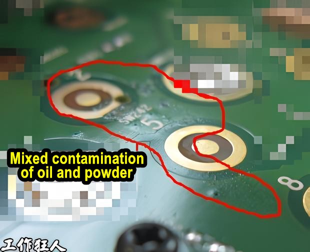 Mixed contamination of oil and powder around PCB keypad contact circuits.
